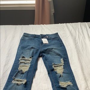 New with tags, mid rise jeans in medium blue wash.